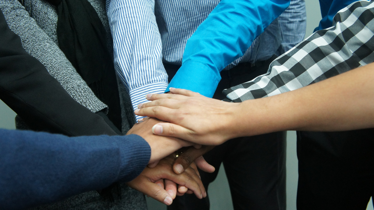 Co-workers with Hands Together